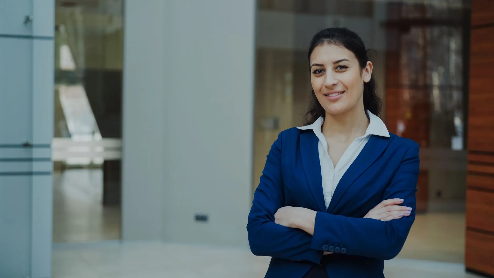 Confident finance advisor standing in a modern office setting