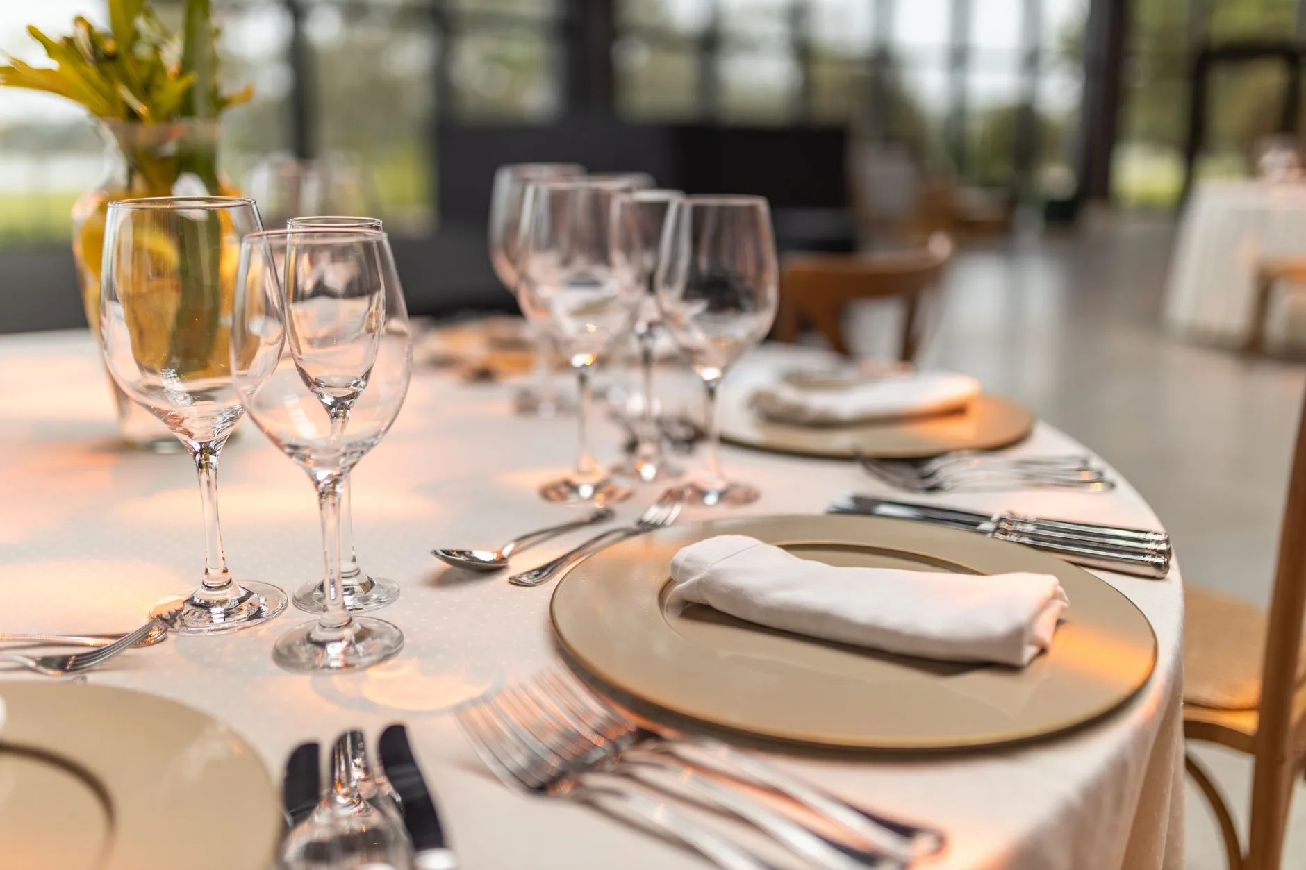 Fine dining table set with elegant glassware, candlelight, and plated dishes