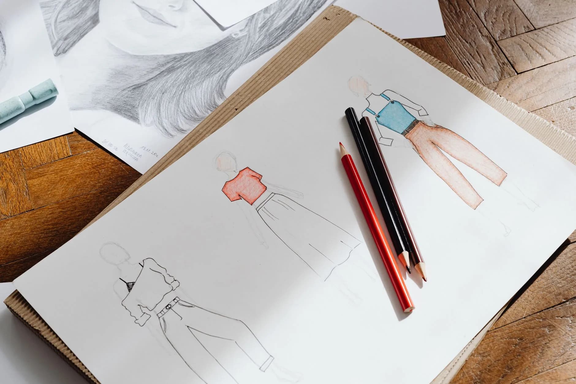 Architectural sketches, notes, and material samples on a studio desk