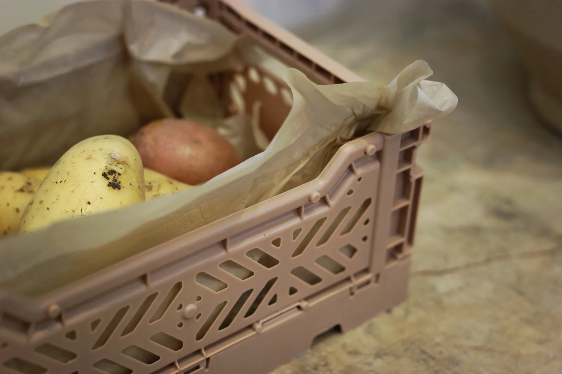 Reusable produce box filled with seasonal vegetables ready for weekly delivery