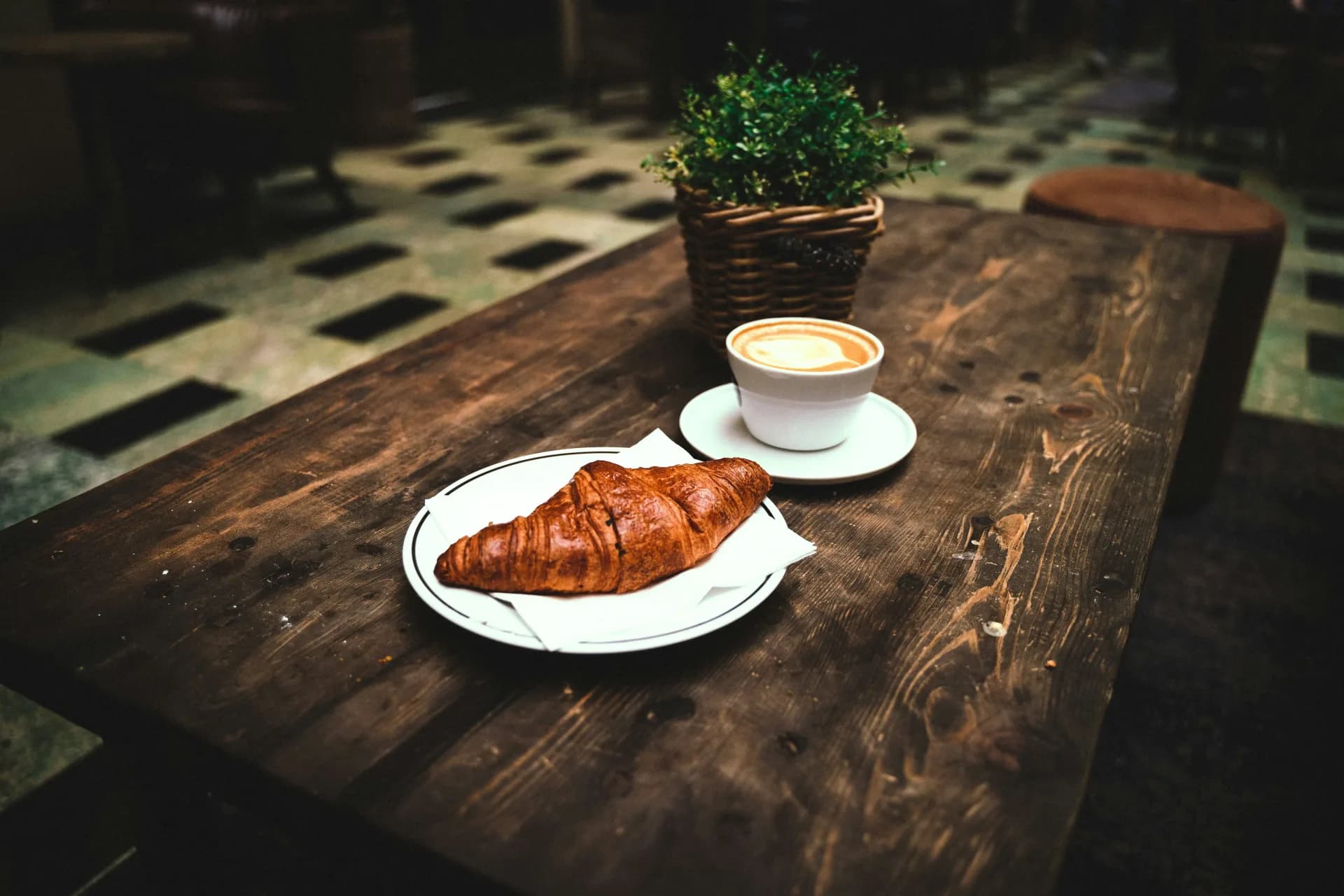 Espresso cup and pastry served on a cafe counter