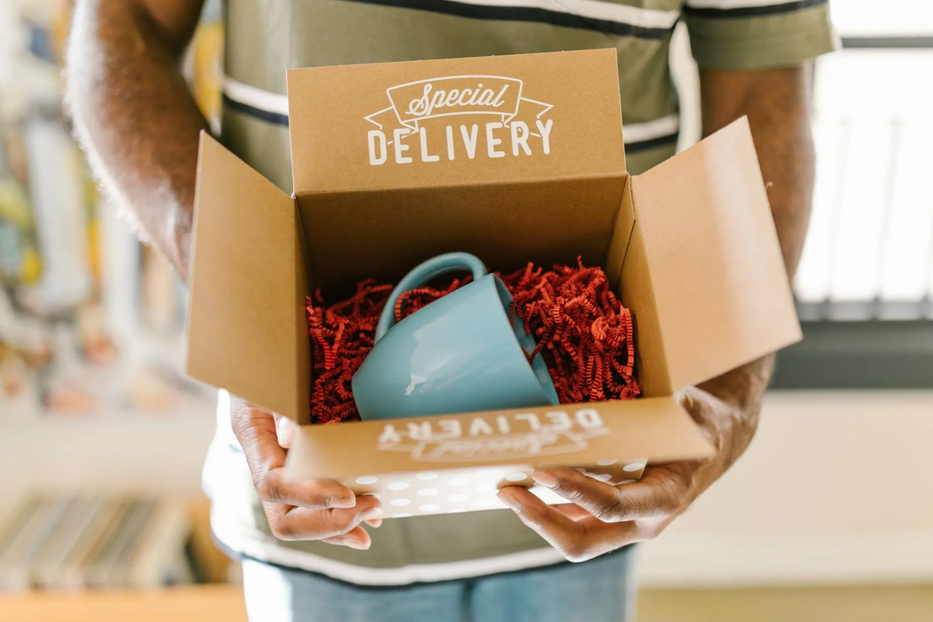 Coffee subscription package with beans, kraft packaging, and a warm home-brewing setup