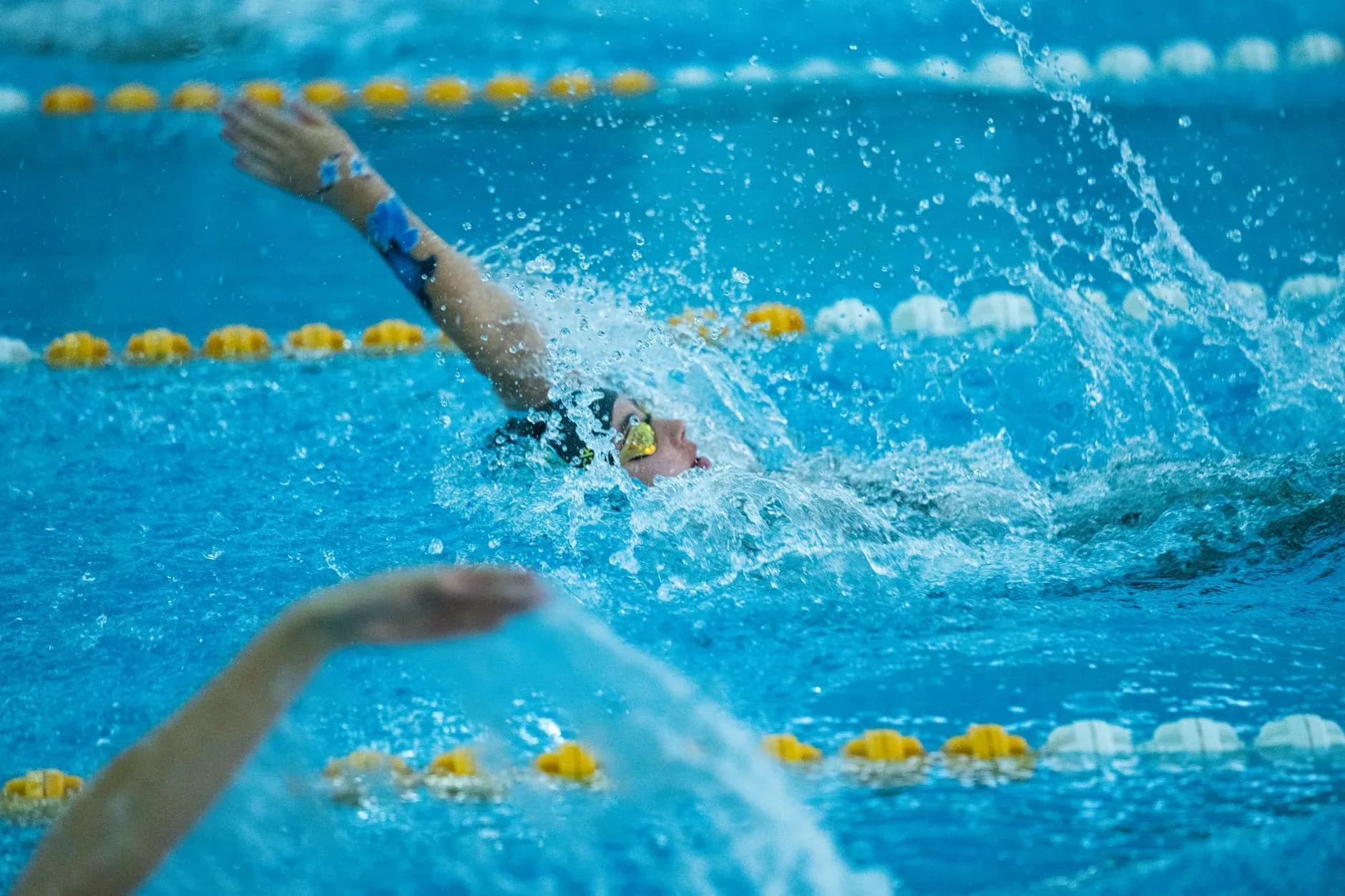 Children attending a holiday swim course in a bright indoor pool