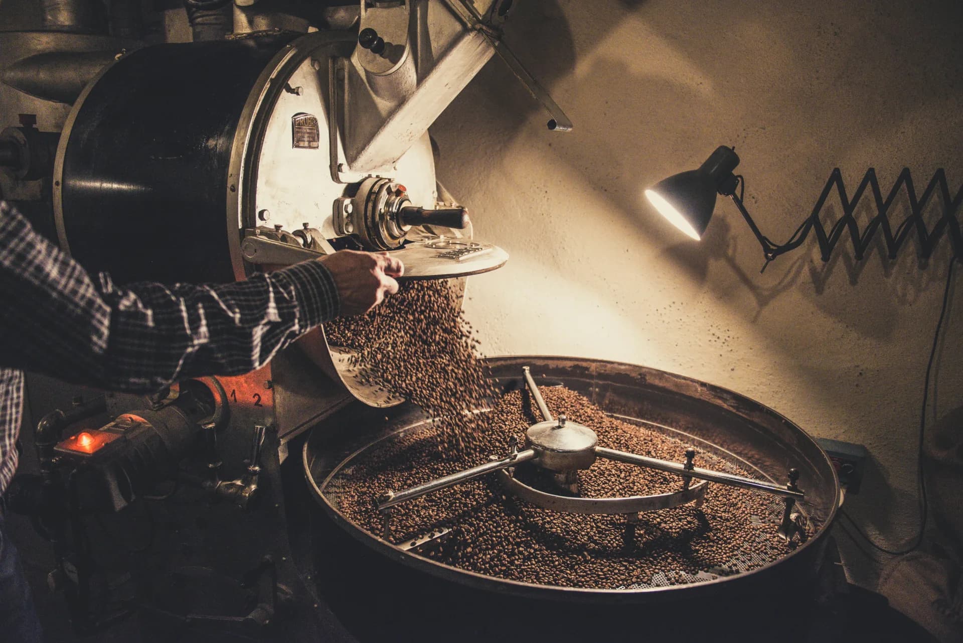 Coffee roastery espresso bar with warm wood, grinder, and cups ready for service