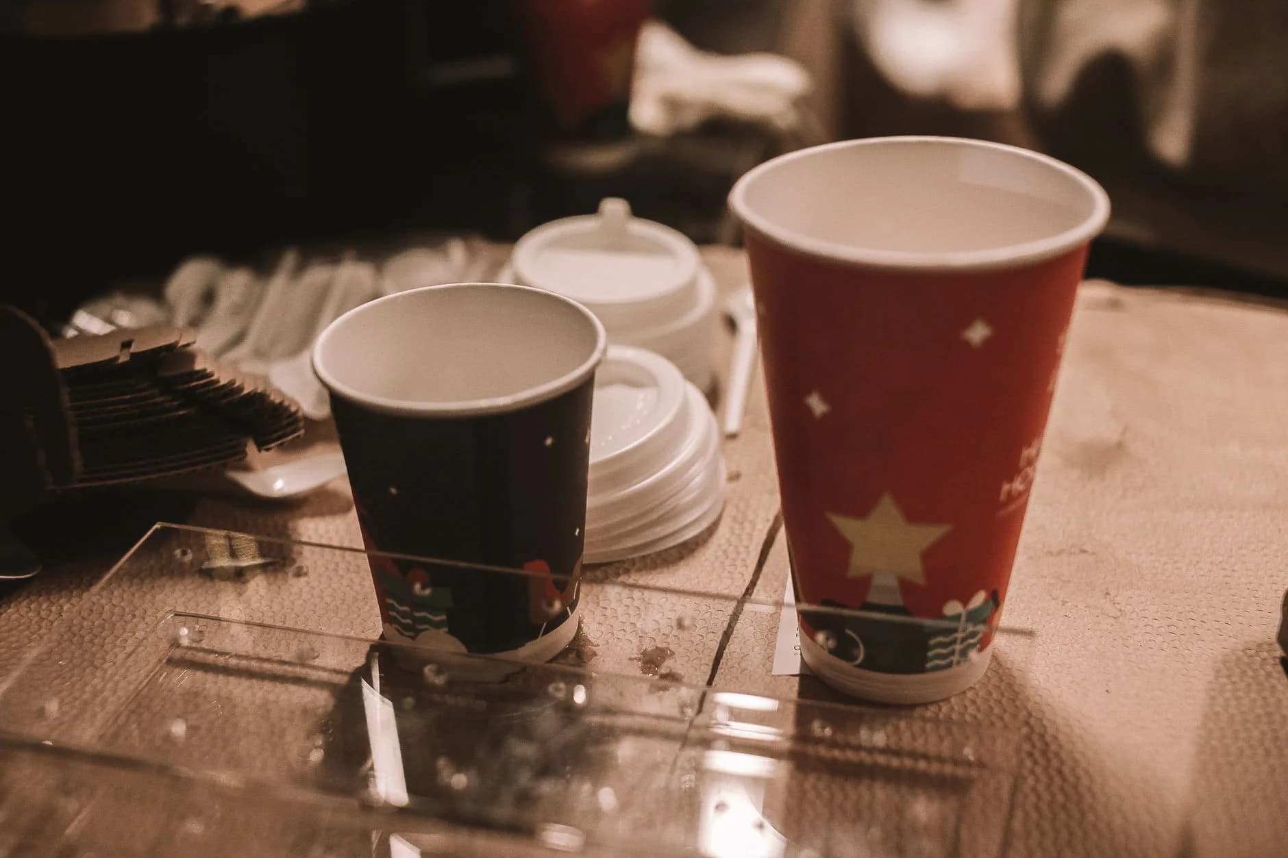 Coffee cups and pastries on a warm café table with natural light