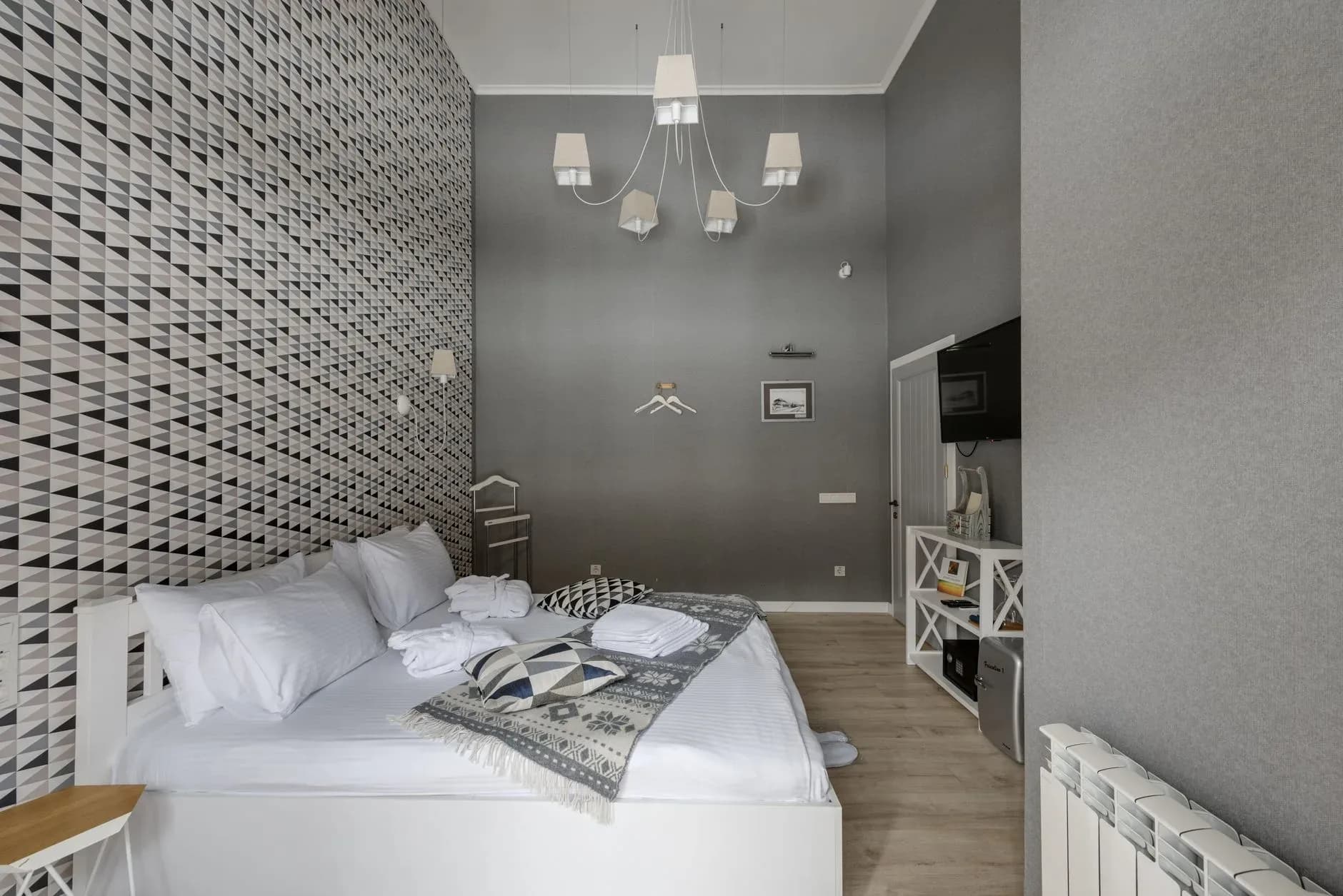 Boutique hotel room with refined linens, warm lighting, and a calm luxury finish