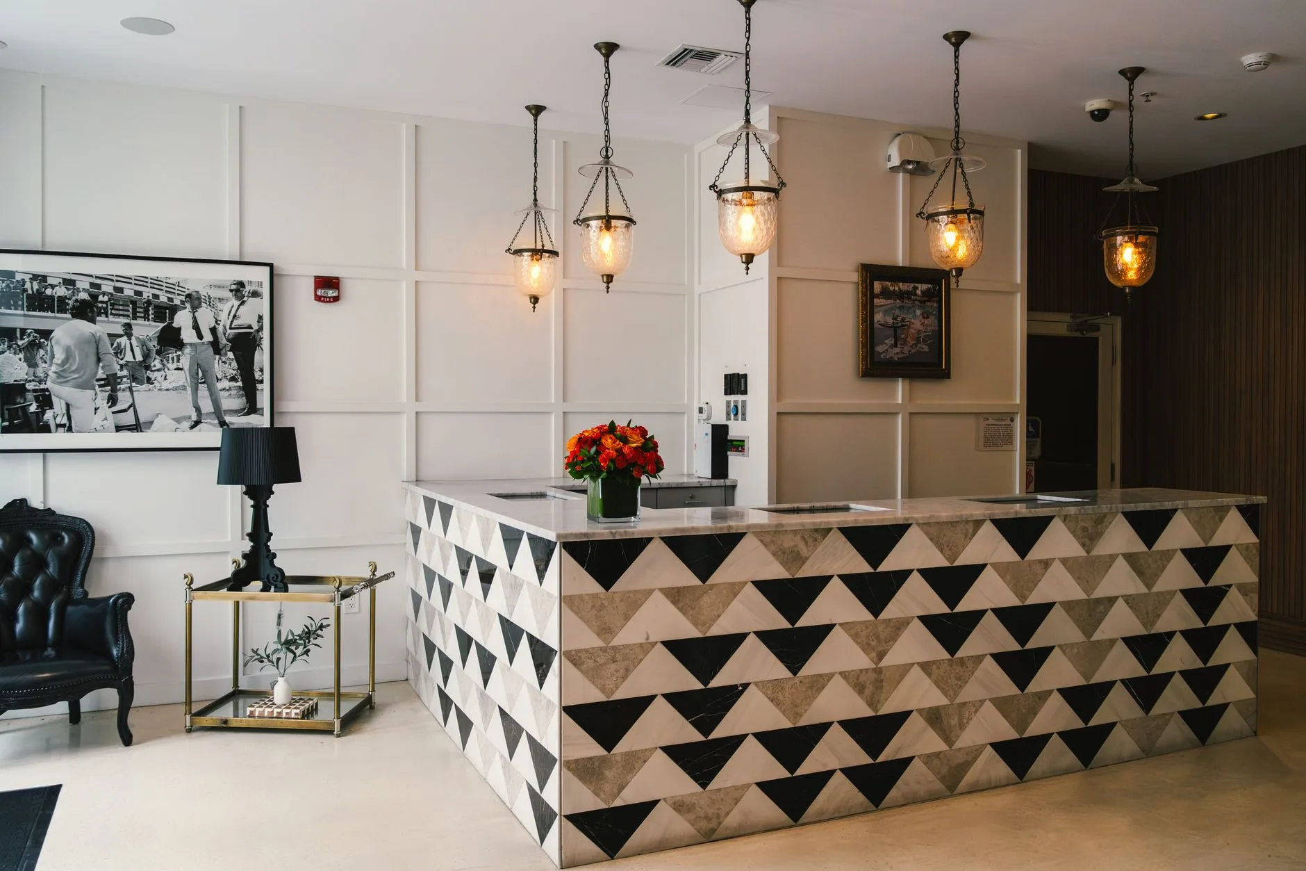 Intimate boutique hotel lobby with layered lighting and handcrafted furnishings