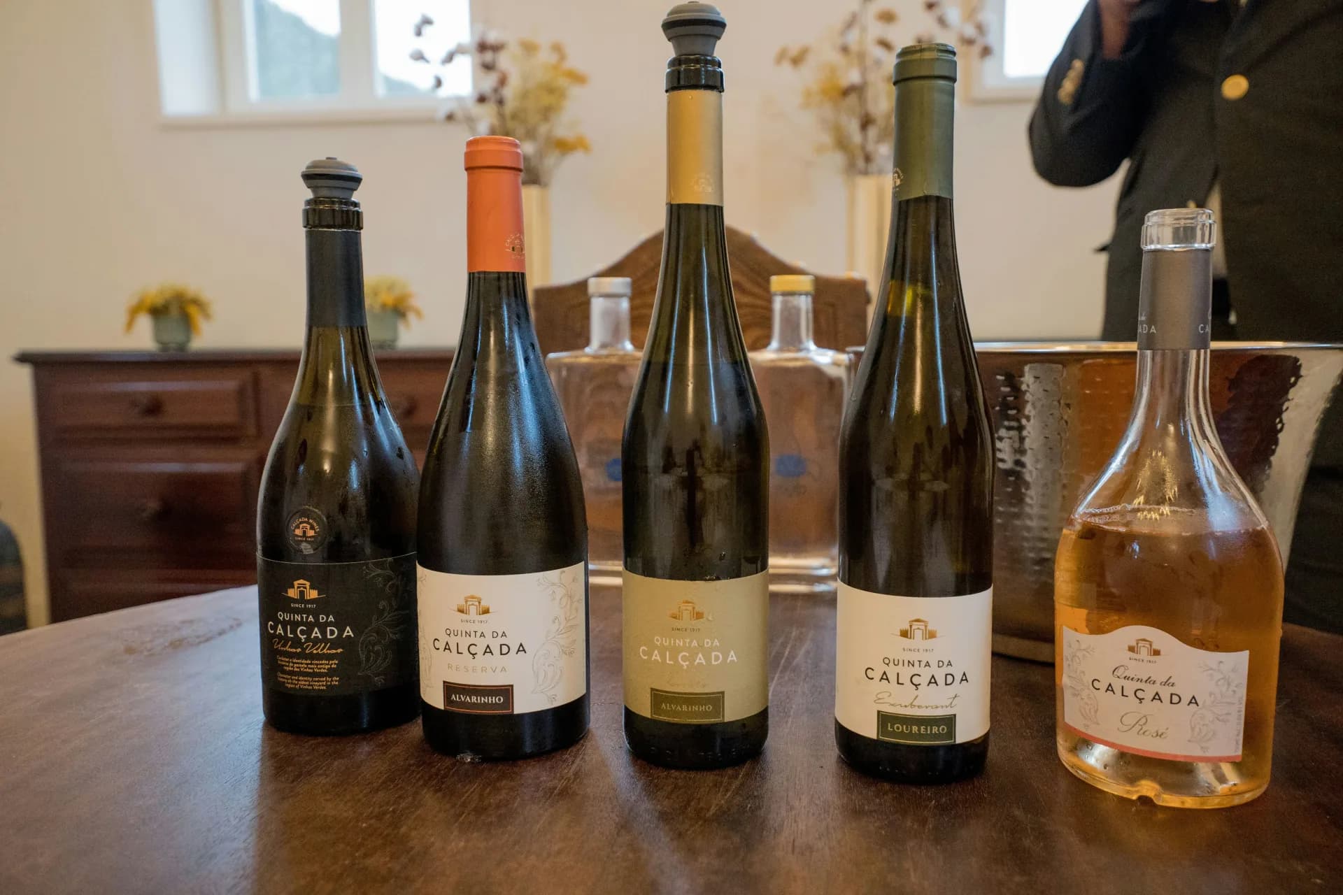 Warm tasting room with glasses and bottles arranged for an evening wine tasting
