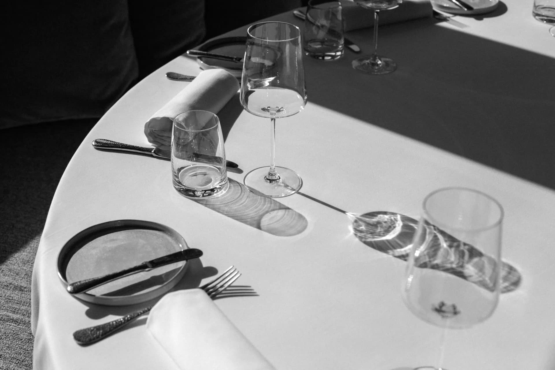 Wine glasses arranged on a tasting table beside handwritten notes